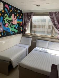 Postel nebo postele na pokoji v ubytování 嘉應賓館HAKKAS GUEST House