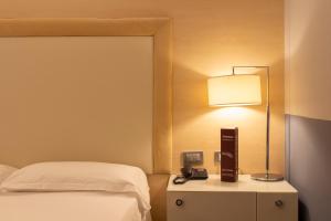A bed or beds in a room at Smy Bologna Centrale