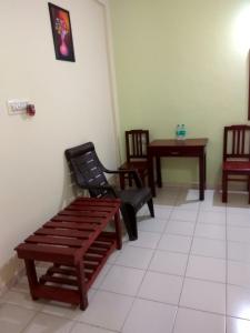 a waiting room with two chairs and a table at Vega Residency in Bangalore