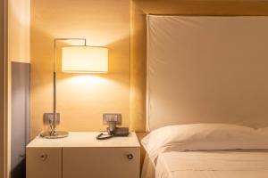 A bed or beds in a room at Smy Bologna Centrale
