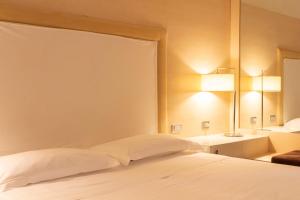 A bed or beds in a room at Smy Bologna Centrale