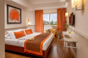 Ein Bett oder Betten in einem Zimmer der Unterkunft Grand Hotel Fleming by OMNIA hotels