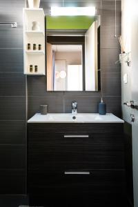 a bathroom with a sink and a mirror at 5* Penthouse Acropoli View Loft in Athens