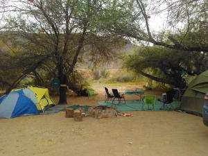 a tent and a table and chairs in a field at Enjo Nature Farm in Cederberg