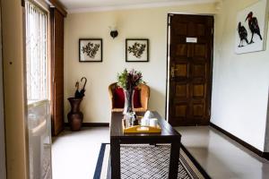 a room with a table and a chair and a door at Cuckoo Ridge Country Retreat in Hazyview