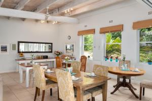 a dining room with a wooden table and chairs at 61 on Camps Bay in Cape Town