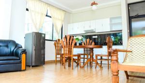 a kitchen and dining room with a table and chairs at Kandy View Hotel in Kandy