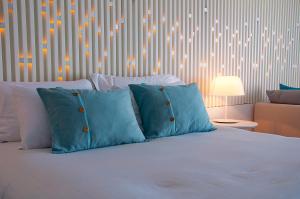 A bed or beds in a room at Nikki Beach Resort & Spa Porto Heli