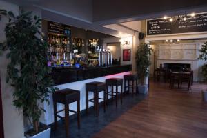 a bar in a restaurant with stools and a counter at Qudos in Salisbury