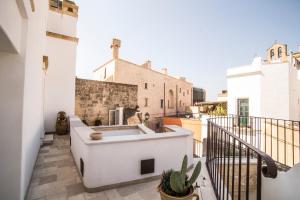 a balcony with a white sink on a building at Corte di Bonifacio - Luxury Suites in Casarano