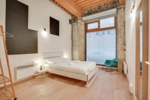 a bedroom with a bed and a large window at NOCNOC - Le Canut in Lyon