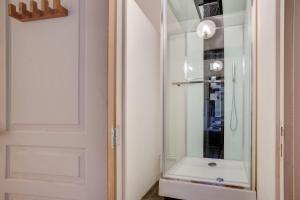 a bathroom with a shower and a glass door at NOCNOC - Le Canut in Lyon