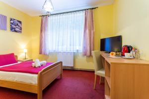 Postel nebo postele na pokoji v ubytování Hotel&Wellness Knížecí rybník