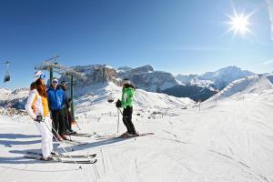 a group of people on skis on a ski slope at Hotel De Fronz in Soraga