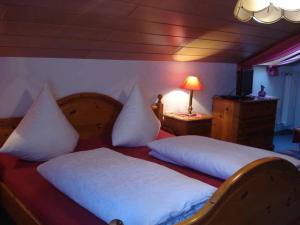 a bedroom with two beds with white pillows at Ferienhotel Münch in Neukirchen beim Heiligen Blut