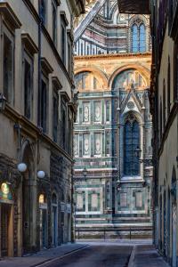 an alley in a city with a building at Palazzo Niccolini al Duomo in Florence