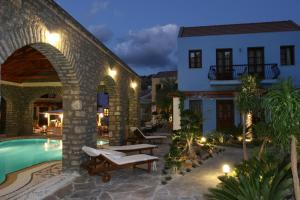 a villa with a swimming pool at night at Iapetos Village in Symi