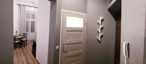 a door to a room with a dining room at Apartamenty Równa in Kielce