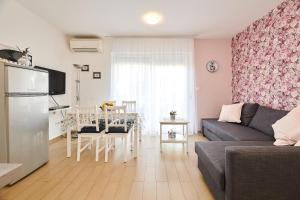 a living room with a couch and a table at Apartments Nina in Umag