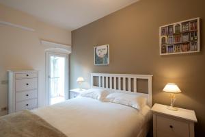 a bedroom with a white bed and a window at San Frediano 56 in Florence +32 photos
