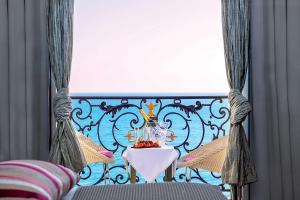 a balcony with a table with a vase on it at Hôtel Le Royal Promenade des Anglais in Nice