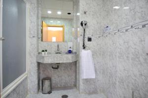 
a bathroom with a sink, toilet and shower stall at Hotel Miramar Playa in Playa de Miramar
