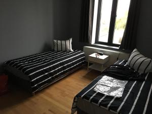 a bedroom with two beds and a window at Appartement Courcelles in Courcelles