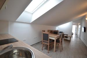 a kitchen and dining room with a skylight at Apartments Tota in Starigrad
