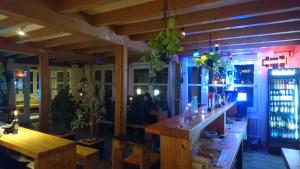 a restaurant with a bar with a table in a room at EASY Lodges Berlin in Berlin