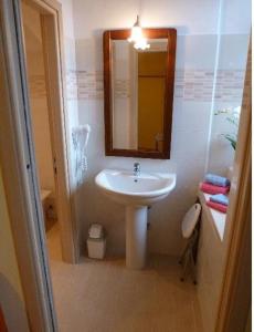 a bathroom with a sink and a mirror at Casa Giardinetto in Stresa