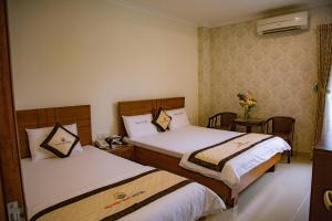 Postel nebo postele na pokoji v ubytování Huynh Duc Hotel
