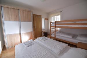 a bedroom with two bunk beds and a window at Apartments Villa Deja in Jahorina