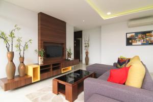 a living room with a couch and a tv at Rozelle by d'best hospitality in Cituja