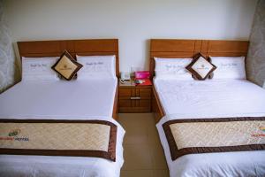 Postel nebo postele na pokoji v ubytování Huynh Duc Hotel