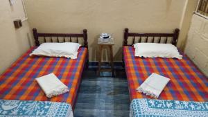 Postel nebo postele na pokoji v ubytování Adams Wood House Ayurveda Homestay Kochi