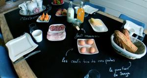 a table with eggs and other food items on it at Maison Boulvern in Plomodiern