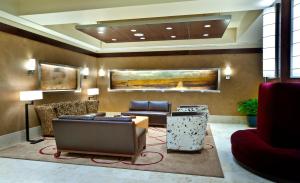 a lobby with a couch and chairs and a table at Northern Hotel in Billings