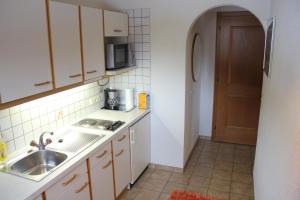 a small kitchen with a sink and a microwave at Haus Netzer Irma in Sankt Gallenkirch +2 photos
