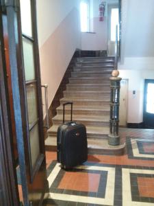 a suitcase sitting on the floor next to a staircase at Studio Ravlić in Zagreb