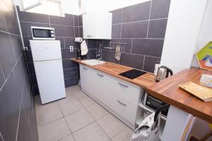 a small kitchen with a white refrigerator and a counter at Ti Barachois in Saint-Denis