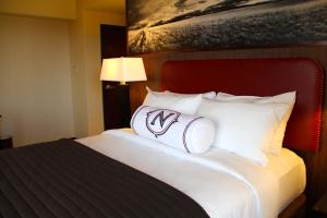 a hotel room with a large bed with white pillows at Northern Hotel in Billings