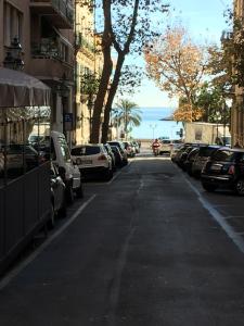 a street with cars parked on the side of the road at Le camere del Corso in Sanremo