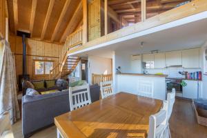 a kitchen and living room with a table and a couch at Chalet Asphodel in Plan Fey