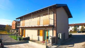 a building with a balcony on the side of it at Bonne Nuit Guest House in Azzano San Paolo