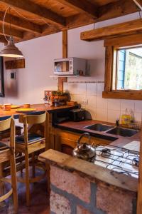 a kitchen with a sink and a stove top oven at Inlandsis Aparts in El Chalten