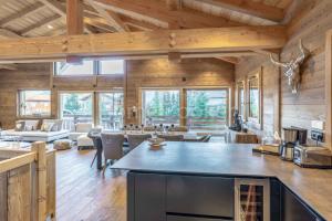 a large living room with wooden walls and ceilings at Chalet Annelya in Combloux