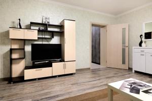 a living room with a flat screen tv on a shelf at PaulMarie Apartments on Yakubovskogo str. in Mogilev