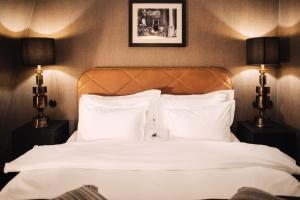 a hotel room with a white bed and a white comforter at NOFO Hotel, WorldHotels Crafted in Stockholm