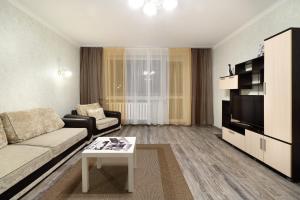 a living room with a couch and a tv at PaulMarie Apartments on Yakubovskogo str. in Mogilev