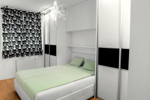 a small bedroom with a bed and a window at Flexible SelfCheckIns 7 - Zagreb - Garage - Electric vehicle ccharger - Loggia - New - Luxury - Apartments Repinc 7 in Zagreb